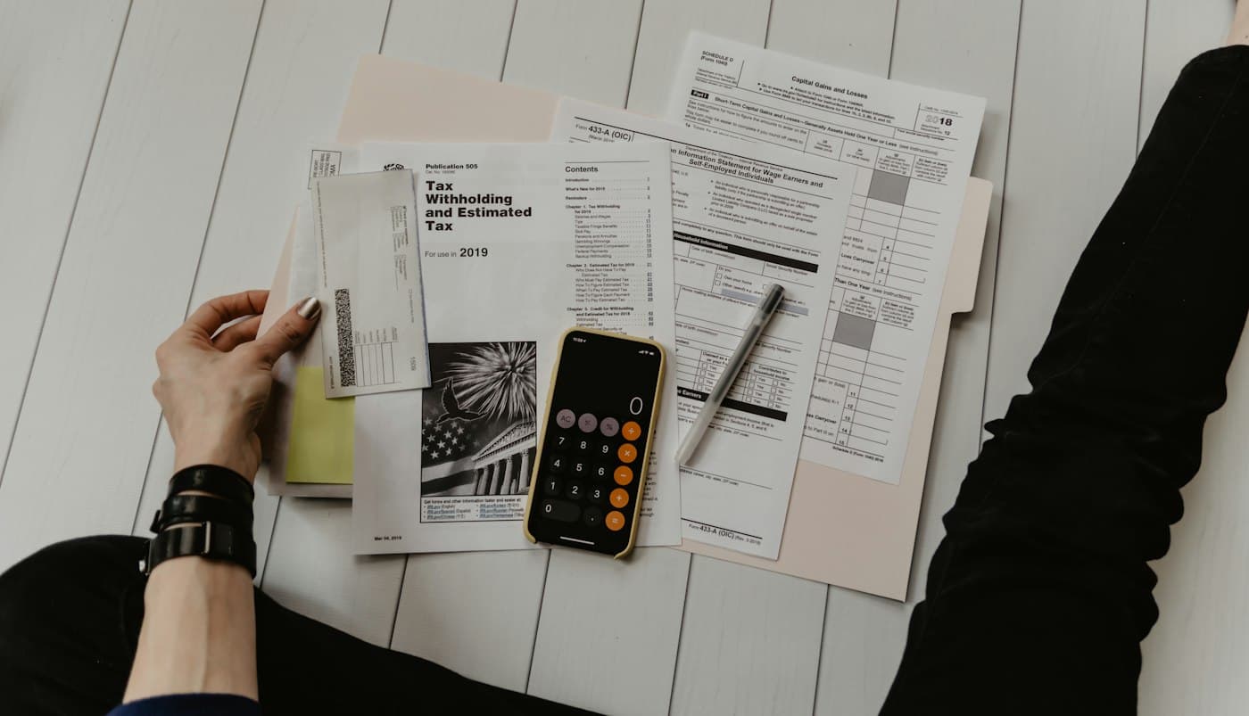 Financial documents and a calculator on a desk